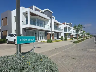 a street sign in front of a apartment building at Spacious & Bright 2BR Apartment, 5min to Beach in Boğaz