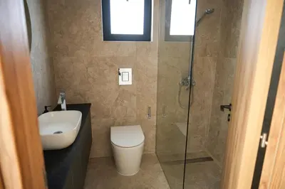 a bathroom with a toilet and a glass shower at 4BR BrandNEW LUX Villa Protaras in Paralimni