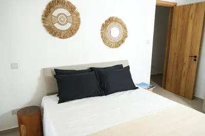 a bedroom with a bed with two mirrors on the wall at 4BR BrandNEW LUX Villa Protaras in Paralimni