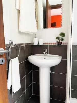 a bathroom with a sink and a mirror at Stylish 2BR Apartment with Balcony and Parking near Saint Lazarus and Finikoudes Beach in Larnaka