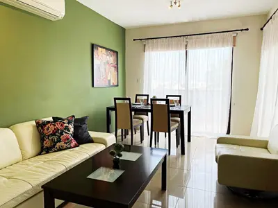 a living room with a couch and a table at Stylish 2BR Apartment with Balcony and Parking near Saint Lazarus and Finikoudes Beach in Larnaka