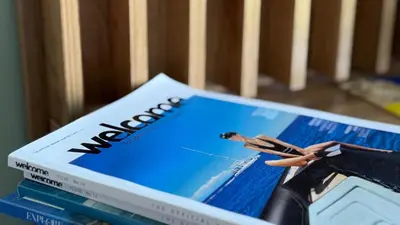 a box of magazines sitting on top of a crib at Too Coool Studio Apartment Coralli Resort in Protaras