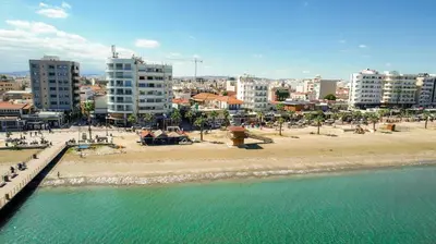 a view of a beach in a city with buildings at Anteia's Seaview Suite just steps from Finikoudes Beach Larnaca in Larnaka