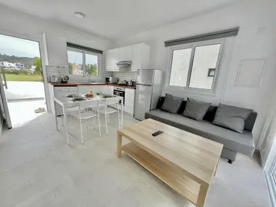 a living room with a couch and a table at Protaras Cozy2bedroom Apartment in Paralimni