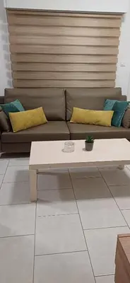 a living room with a couch and a coffee table at Makenzy Mermaid 2 Bedroom Apartment in Larnaka