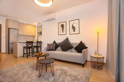 a living room with a couch and a table at Crown Hall Suites in Limassol