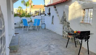 a patio with a grill and chairs and a table at Landina villa in Protaras