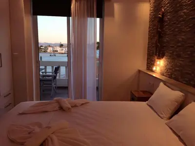 a bedroom with a bed with a view of a balcony at Advice Deluxe in Nicosia