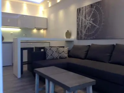a living room with a couch and a table at Advice Deluxe in Nicosia