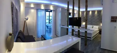a living room with a white couch and a tv at Advice Deluxe in Nicosia