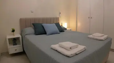 a bedroom with a large bed with two towels on it at Celestial Villa in Ayia Napa