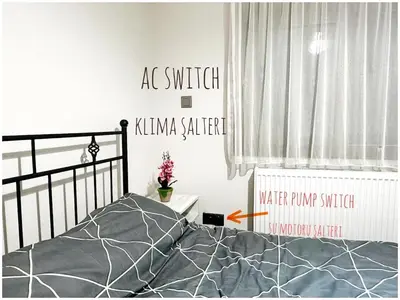 a bedroom with a bed with a poster on the wall at Cheerful and cozy Bungalow with pool and fireplace in Athalassa