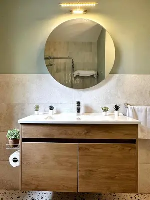 a bathroom with a sink and a mirror at Cheerful and cozy Bungalow with pool and fireplace in Athalassa