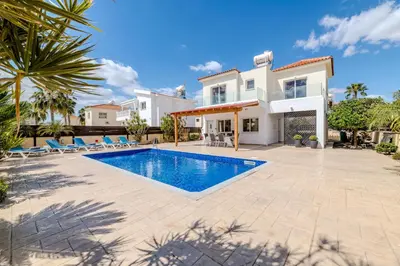 a villa with a swimming pool and a house at Marika Heights in Ayia Napa