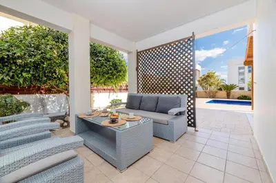 a patio with a couch and a table at Marika Heights in Ayia Napa