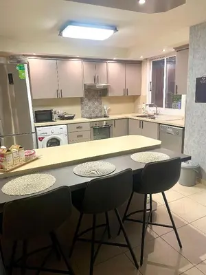 a kitchen with a table and chairs in it at Charming Oroklini Penthouse with Ocean Views and Private Parking in Voroklini