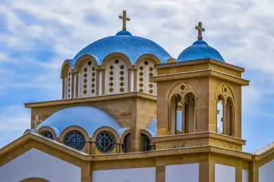 a church with blue domes and a cross on top at Charming Oroklini Penthouse with Ocean Views and Private Parking in Voroklini