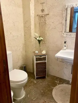 a bathroom with a toilet and a sink at Charming Oroklini Penthouse with Ocean Views and Private Parking in Voroklini
