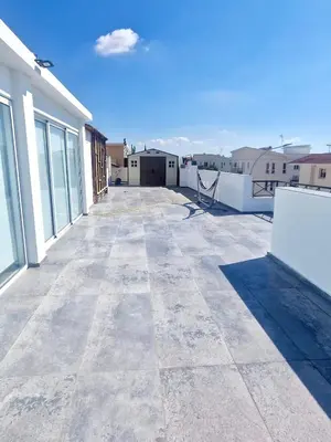a view of a large patio on a building at Charming Oroklini Penthouse with Ocean Views and Private Parking in Voroklini