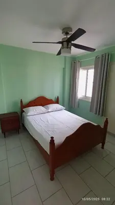 a bedroom with a bed and a ceiling fan at Emiliano 7 Holiday Apartment in Larnaka