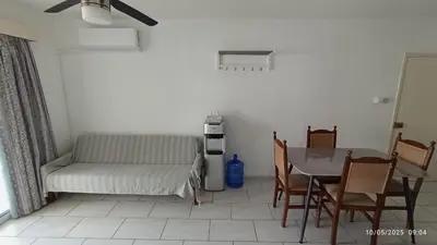 a living room with a table and a couch at Emiliano 7 Holiday Apartment in Larnaka