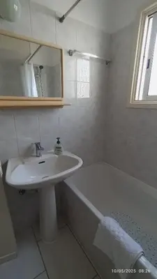 a white bathroom with a sink and a bath tub at Emiliano 7 Holiday Apartment in Larnaka