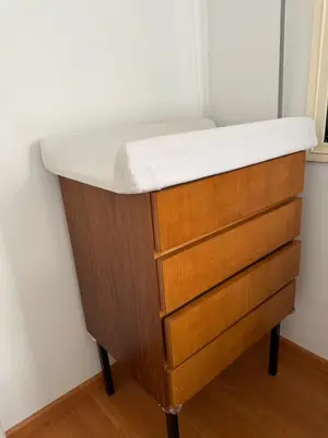 a wooden dresser with a white counter top on top at Beachfront apartment with Kids Room, Pool & 2 Workspaces in Limassol