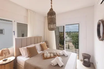 a bedroom with a bed and a large window at EvelMar Villa in Protaras
