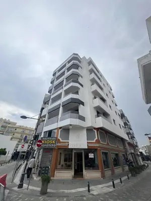 a tall building on a city street with at Sia-Serenity Finikoudes Apartment in Larnaka