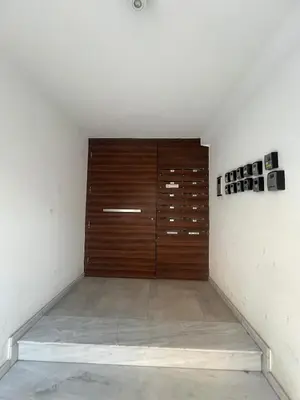a room with a wooden door in a wall at Sia-Serenity Finikoudes Apartment in Larnaka