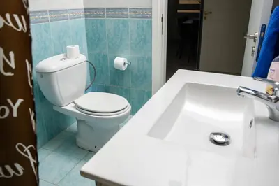 a bathroom with a white sink and a toilet at Ariel 3 bed Apartment in Larnaka