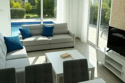 a living room with a couch and a coffee table at Too Coool Villa Milos Lifestyle in Protaras