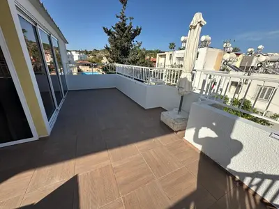 a balcony of a house with a wooden floor at Emerald Luxe in Ayia Napa