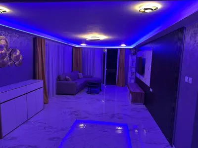 a purple room with a couch and a tv at Emerald Luxe in Ayia Napa