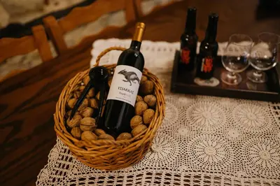 a basket with a bottle of wine and some wine glasses at Apanemia Inn House in Lofou
