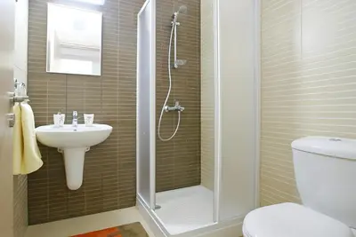 a bathroom with a shower and a toilet and a sink at Too Coool 1 Bedroom Apartment Coralli Resort in Protaras