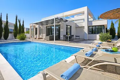 a villa with a swimming pool and a house at Villa Camellia - 3bed Bungalow large pool in Protaras