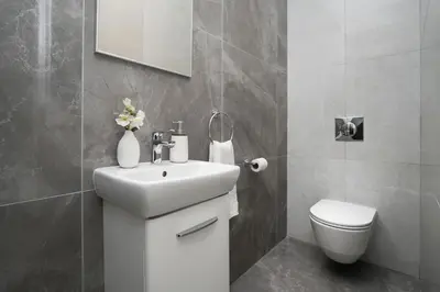 a bathroom with a white sink and a toilet at Villa Camellia - 3bed Bungalow large pool in Protaras
