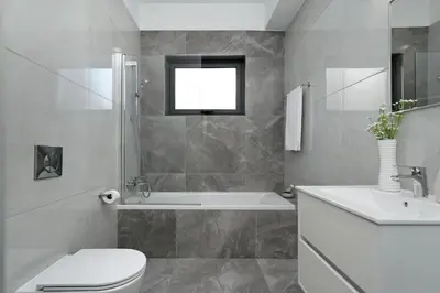 a bathroom with a tub and a toilet and a sink at Villa Camellia - 3bed Bungalow large pool in Protaras