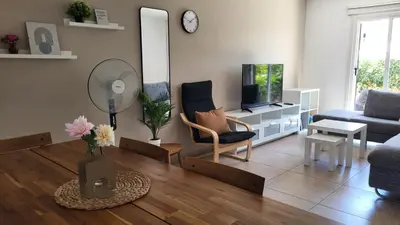a living room with a couch and a tv at HANA Holiday house in Ayia Napa
