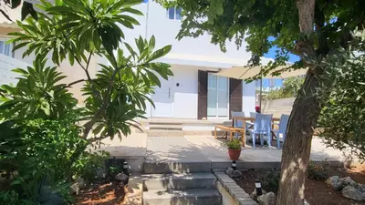 a backyard with a table and chairs and trees at HANA Holiday house in Ayia Napa