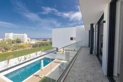 a view from the balcony of a house with a swimming pool at Protaras Aqua Villa AQ05 in Protaras