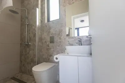 a bathroom with a toilet and a sink and a shower at Protaras Aqua Villa AQ05 in Protaras