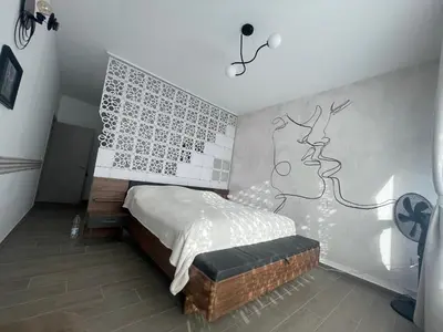 a bedroom with a bed and a wall with a drawing on it at Mountain Villa in Prodromos with Fireplace & Sauna in Prodromos