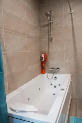a bath tub with a shower in a bathroom at Mountain Villa in Prodromos with Fireplace & Sauna in Prodromos