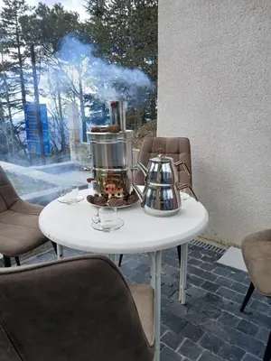 a table with a tea pot and a tea kettle at Mountain Villa in Prodromos with Fireplace & Sauna in Prodromos