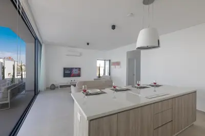 a kitchen with a counter with wine glasses on it at Aqua 4 Bedrooms in Paralimni