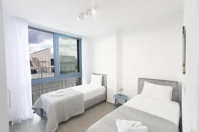 a bedroom with two beds and a window at Aqua 4 Bedrooms in Paralimni
