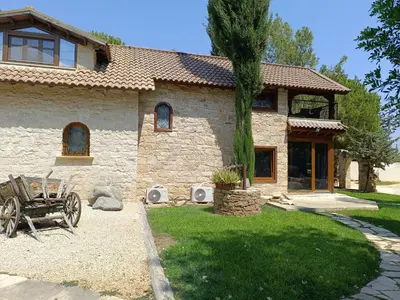 a stone house with a wagon in front of it at Stone Garden Oasis Cottage in Limassol