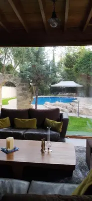 a living room with a couch and a table at Stone Garden Oasis Cottage in Limassol
